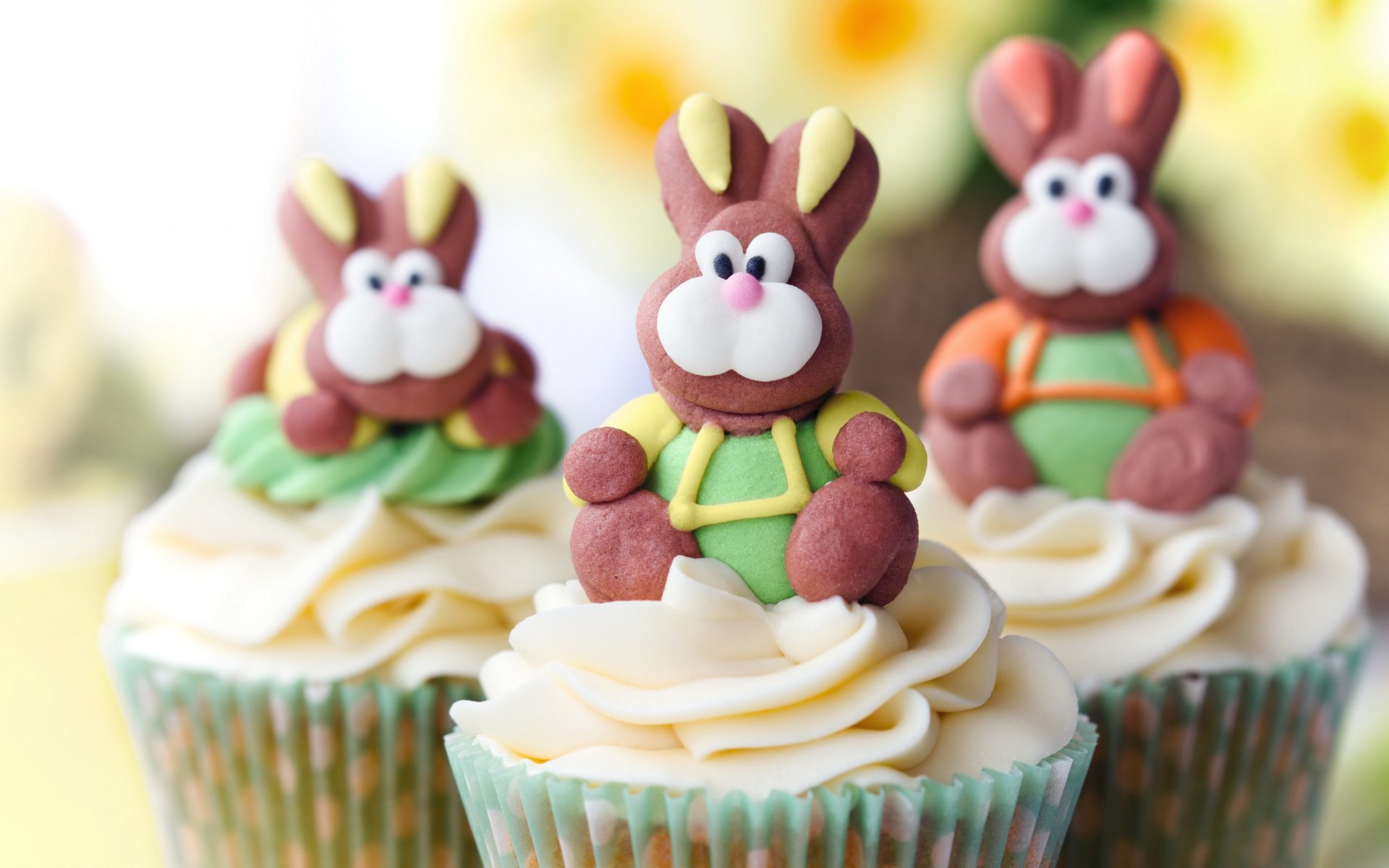 HD PC desktop wallpaper featuring cupcakes topped with detailed bunny-shaped decorations, set against a soft, blurred floral background.