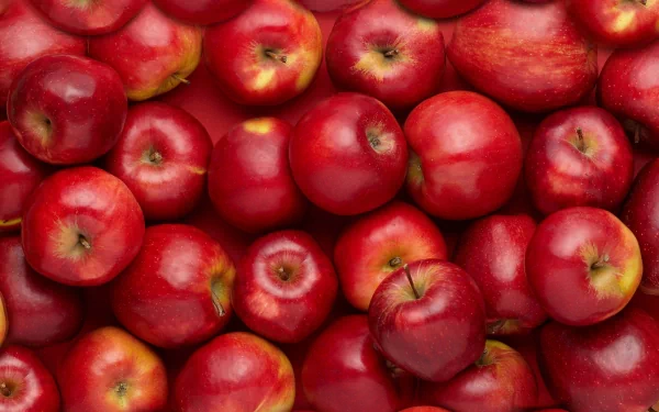 A vibrant collection of red apples arranged closely, creating a rich texture and color, suitable as an HD PC desktop wallpaper or background.