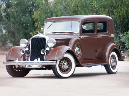 A vintage 1933 Dodge DP 4-Door Salon Brougham, featuring a rich brown exterior and classic design, showcased as a high-definition desktop wallpaper and background.