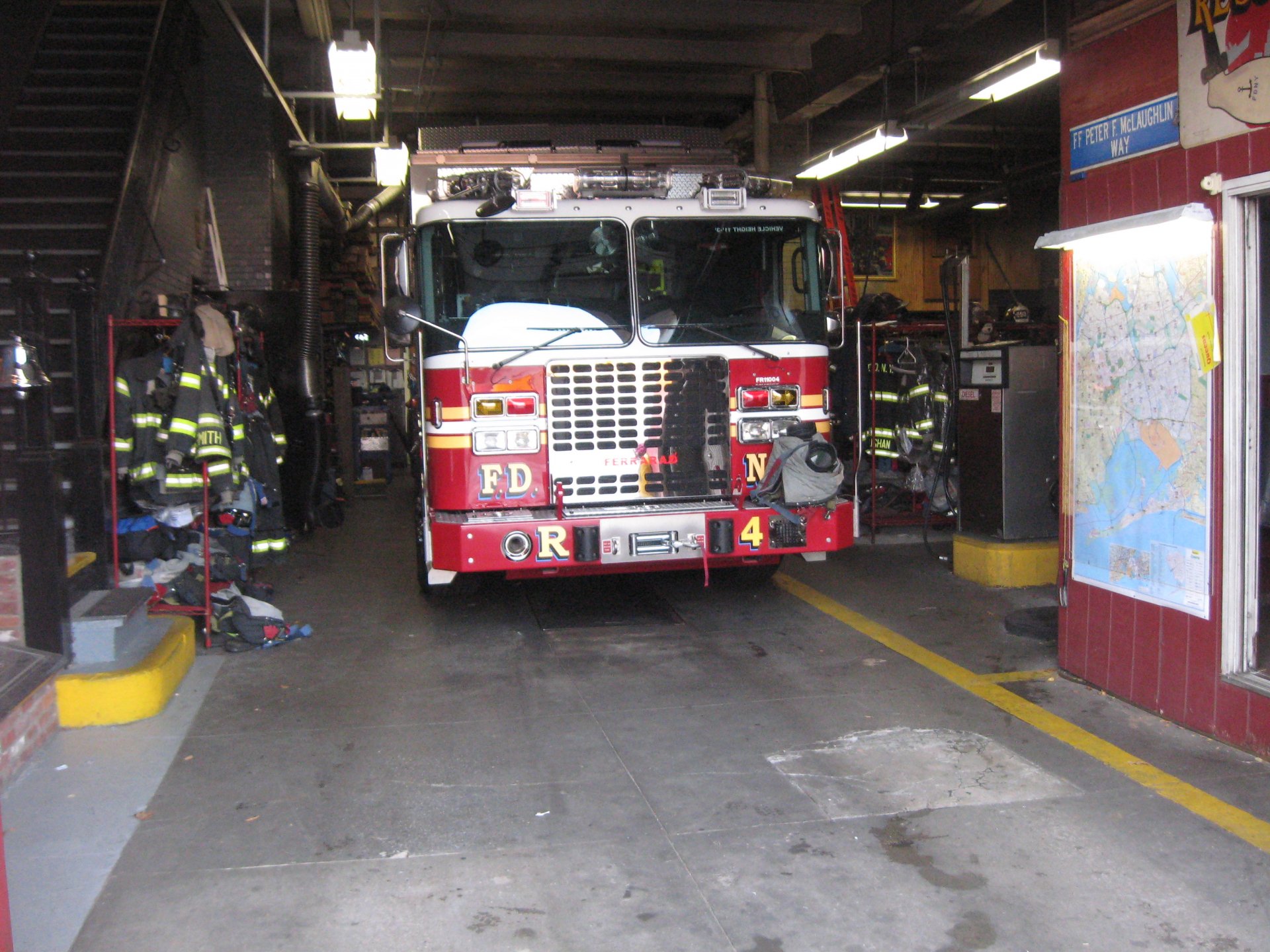 Ferrara fire truck vehicle — a red fire engine parked inside a fire station bay, captured as a 2K Quad HD PC desktop wallpaper and background.