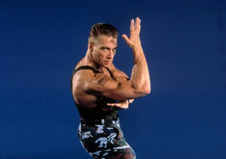 HD PC desktop wallpaper featuring a muscular character from the Street Fighter movie striking a martial arts pose against a solid blue background.