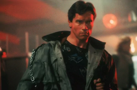 HD PC desktop wallpaper featuring a scene from the movie The Terminator with the character in a dimly lit, intense atmosphere.