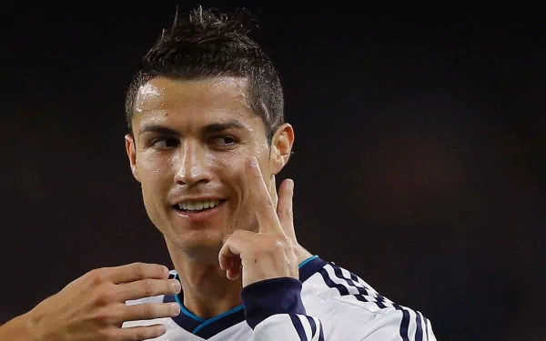HD desktop wallpaper featuring Cristiano Ronaldo in a Real Madrid C.F. jersey, engaged in a moment during a sports event.