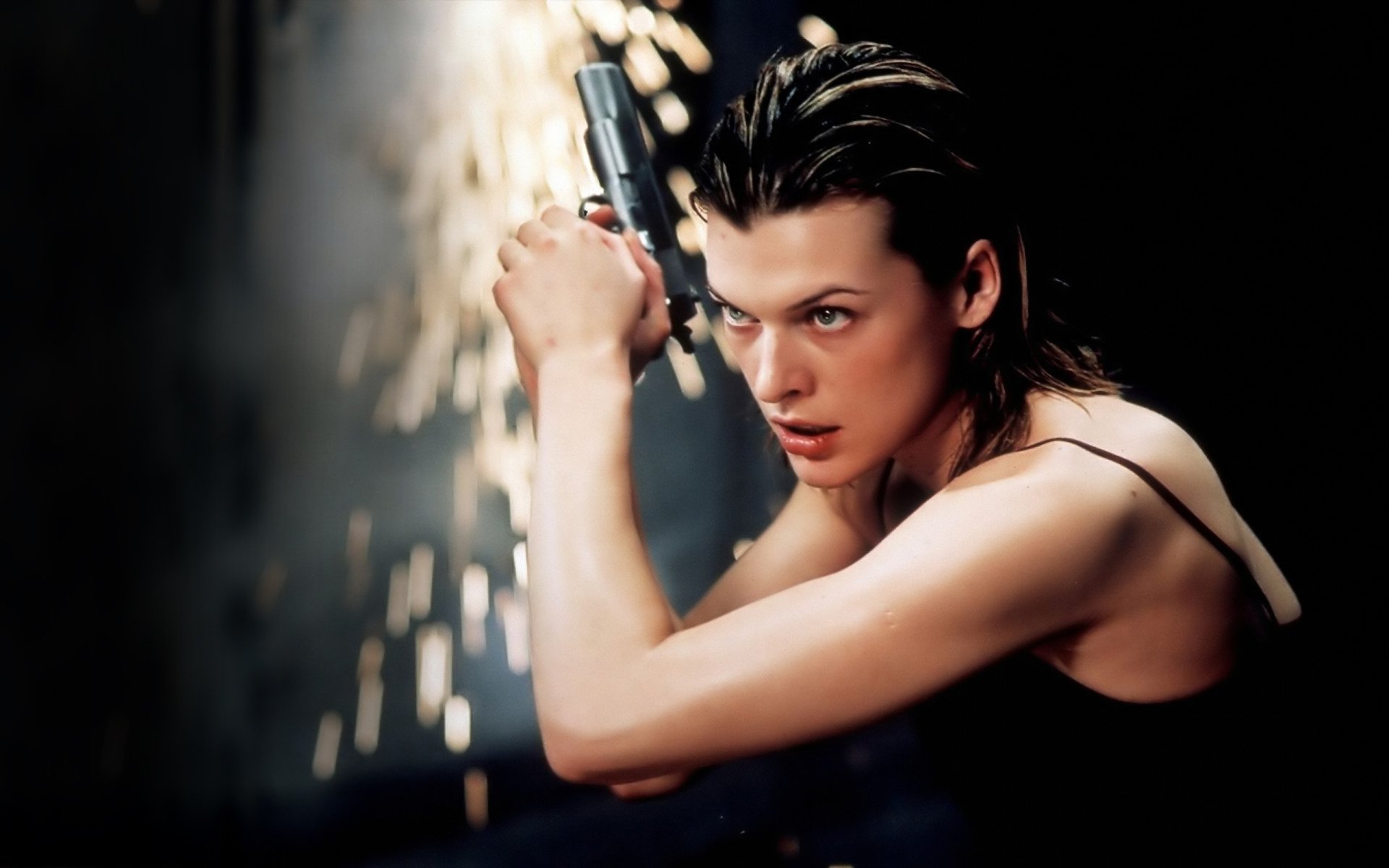 Milla Jovovich in a dynamic pose with a gun, set against an action-packed background from the movie Resident Evil. A striking HD desktop wallpaper that captures the film's intensity.