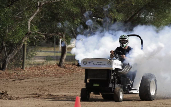 A tractor emits thick smoke while performing a burnout on a dirt path, captured in 4K Ultra HD for a dynamic PC desktop wallpaper and background.
