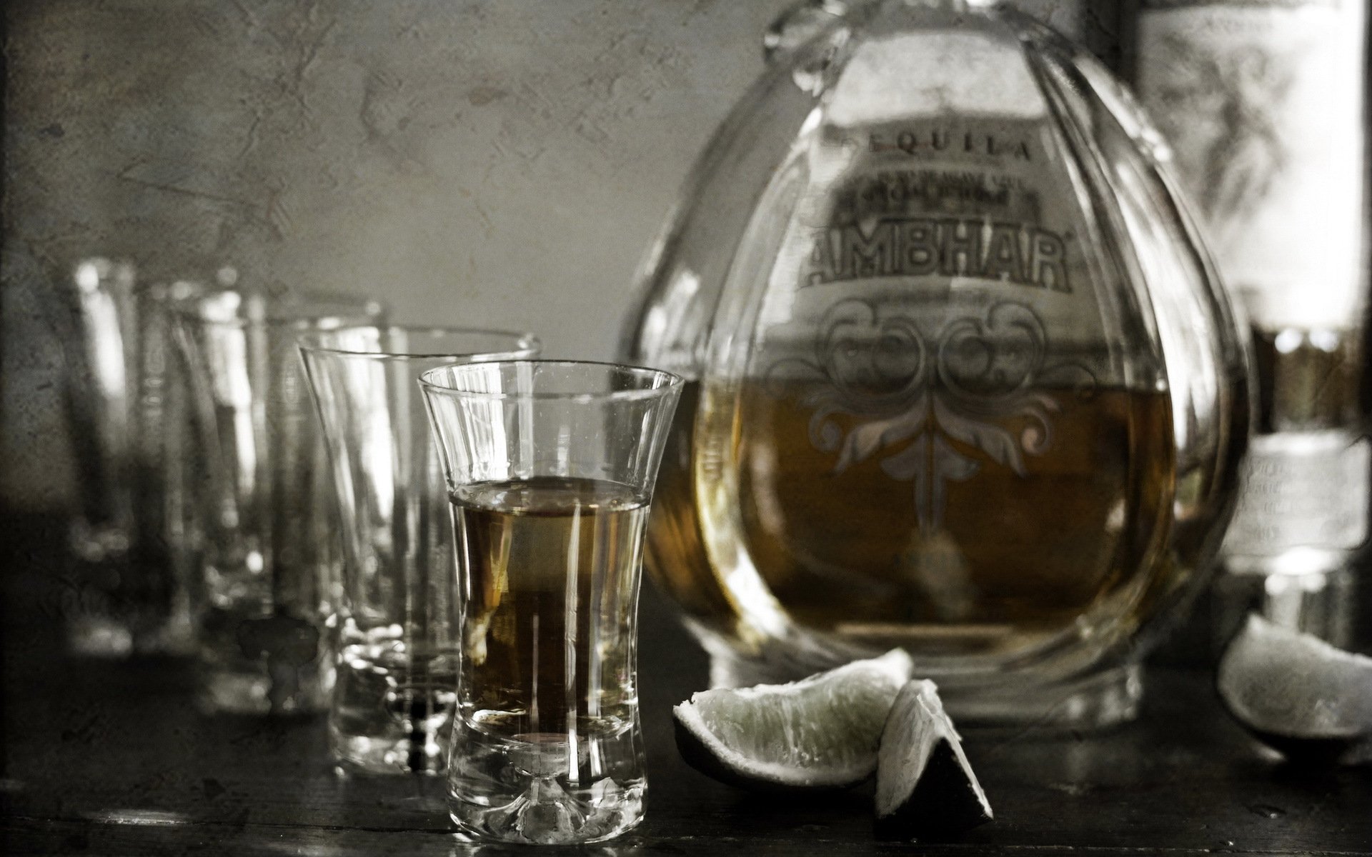 HD desktop wallpaper featuring a close-up of whisky glasses and a bottle, accompanied by lime wedges, highlighting a refined food and whisky theme.