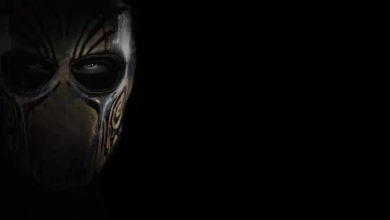 HD PC desktop wallpaper showing a half-visible ornate combat mask and eye against black — Army Of Two (video game).