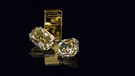 A stunning HD desktop wallpaper featuring a gold bar and two sparkling gemstones, set against a sleek black background, showcasing their luxurious allure.
