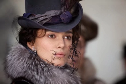 HD desktop wallpaper featuring a close-up of Keira Knightley as Anna Karenina from the 2012 movie, dressed in period costume with a hat and fur collar.