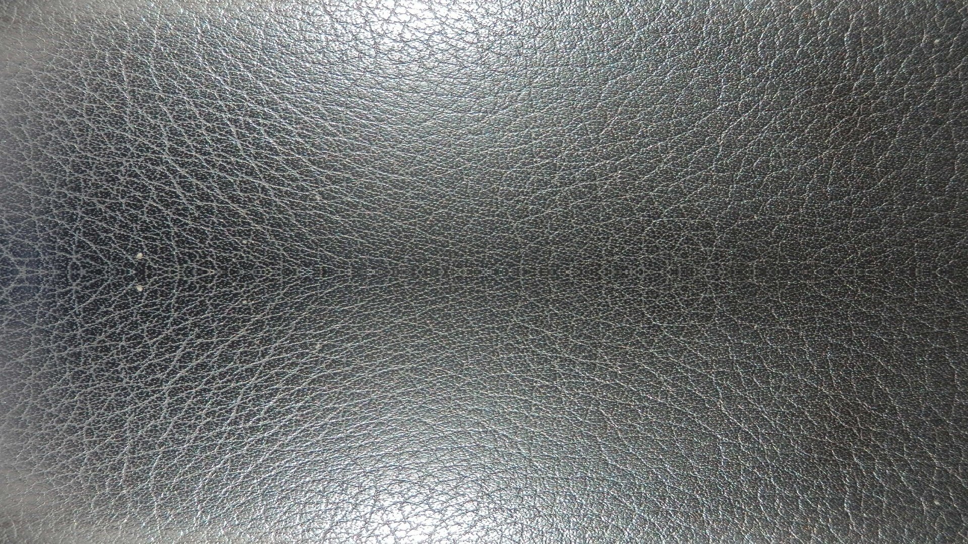 HD PC desktop wallpaper featuring an abstract textured surface resembling dark, cracked leather with subtle lighting variations.