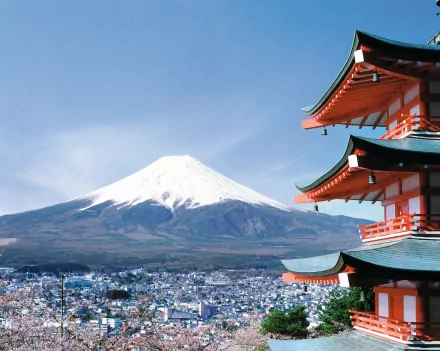 A stunning HD desktop wallpaper featuring a traditional pagoda with vibrant architecture, set against the majestic backdrop of Mount Fuji and a clear blue sky.