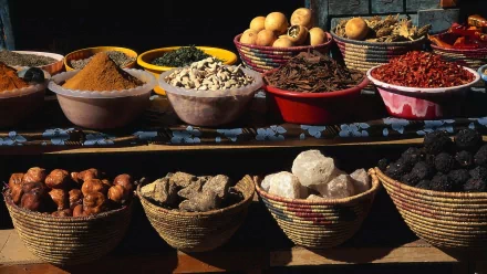 A vibrant display of various herbs and spices in colorful bowls, showcasing their rich textures and hues, serves as an enticing HD desktop wallpaper.