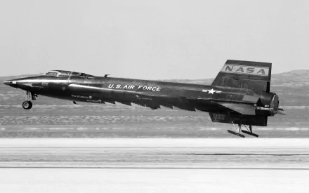 Black and white 4K Ultra HD image of the North American X-15 military aircraft taking off, marked with U.S. Air Force and NASA insignia, set against a desert runway background.