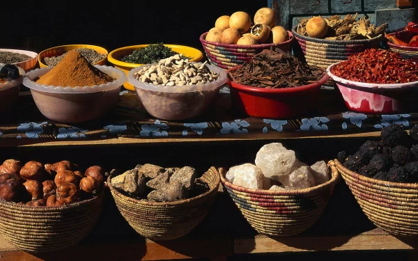A vibrant display of various herbs and spices in colorful bowls, showcasing their rich textures and hues, serves as an enticing HD desktop wallpaper.