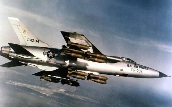 HD desktop wallpaper of a US Air Force Republic F-105 Thunderchief military jet flying in the sky, showcasing its distinctive design and weaponry.