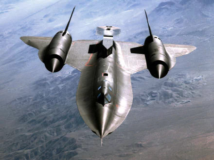 A high-definition desktop wallpaper featuring the Lockheed SR-71 Blackbird military reconnaissance aircraft flying over a mountainous landscape.