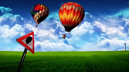 HD PC desktop wallpaper: two colorful hot-air balloons float above a lush green meadow under a vivid sky, a dreamy-world nature scene with a tilted road sign in the foreground.