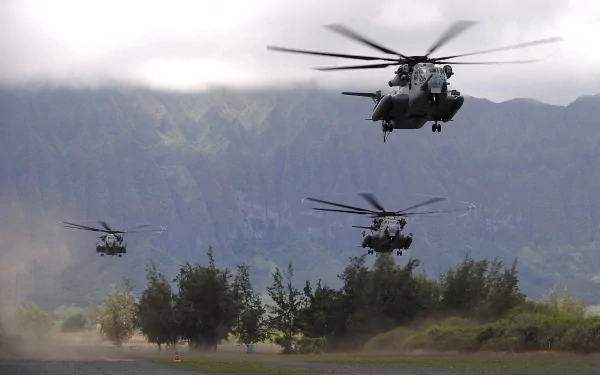 HD desktop wallpaper showing three military Sikorsky CH-53E Super Stallion helicopters flying over a landscape with trees and mountains in the background.