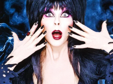 HD PC desktop wallpaper featuring Elvira from the TV show Elvira's Movie Macabre, showcasing her iconic gothic style and dramatic expression.