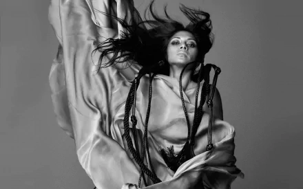 Black and white HD desktop wallpaper featuring Nicole Scherzinger with flowing hair and draped fabric, capturing a dramatic and artistic music-themed portrait.
