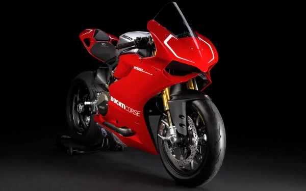 HD PC desktop wallpaper of a sleek red Ducati motorcycle against a black background, showcasing its modern design and sporty details.