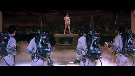 HD PC desktop wallpaper from the movie Ghostbusters: four Ghostbusters with proton packs confront a towering supernatural figure on a misty rooftop skyline.