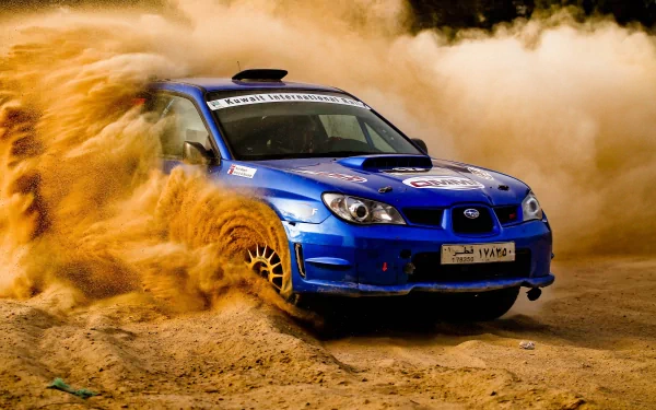 A dynamic Subaru rally car kicks up dust while navigating a rugged terrain, capturing the thrilling essence of rallying in this stunning 4K Ultra HD desktop wallpaper.