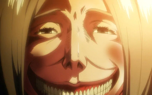 HD desktop wallpaper from Attack On Titan featuring a close-up of a grinning character with golden hair and shining eyes.