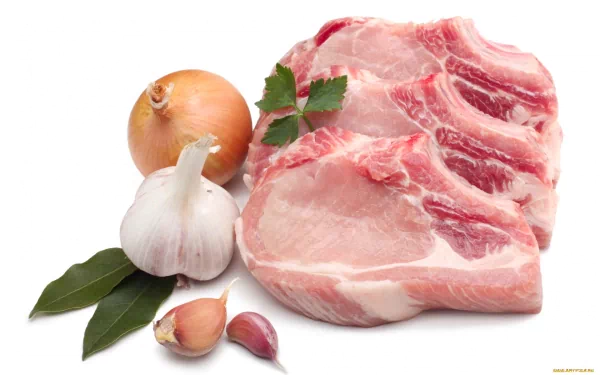 Fresh cuts of meat are displayed alongside onions, garlic, and bay leaves, creating a vibrant composition. This HD desktop wallpaper captures the essence of flavorful cooking.