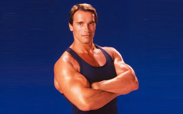 A muscular Arnold Schwarzenegger poses confidently against a blue background, making for an impactful HD desktop wallpaper and background.