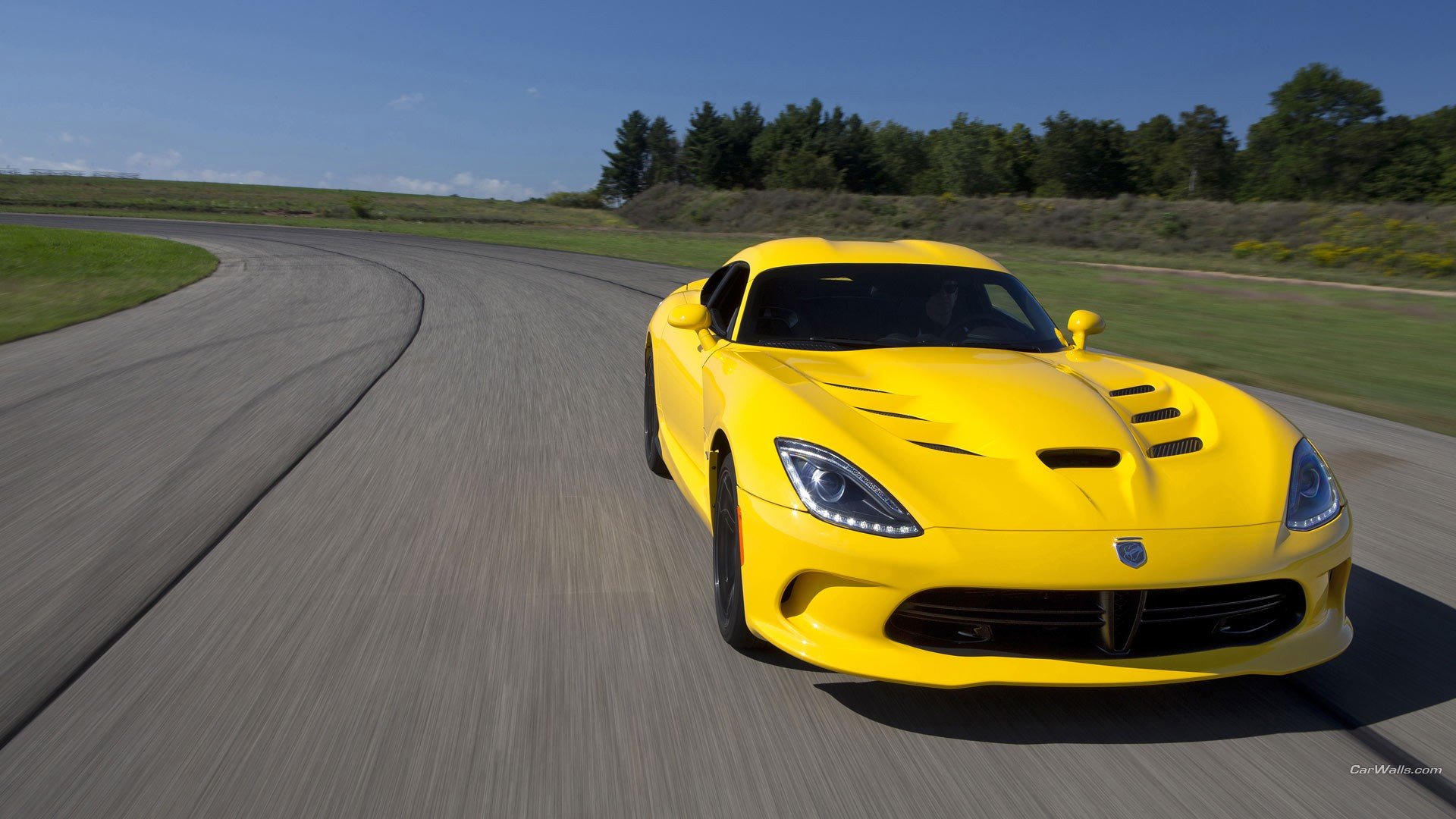 Yellow Dodge Viper speeding on a racetrack, dynamic low-angle shot — HD PC desktop wallpaper/background.