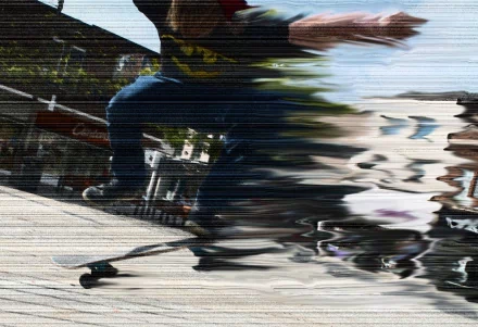 HD desktop wallpaper featuring a dynamic skateboarder captured mid-trick with motion blur, emphasizing speed and energy in skateboarding sports.