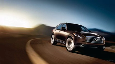 HD PC desktop wallpaper/background: Infiniti QX70 SUV driving on a winding desert road at sunset, motion blur with distant mountains and a dramatic sky.