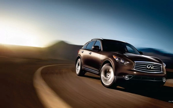 HD PC desktop wallpaper/background: Infiniti QX70 SUV driving on a winding desert road at sunset, motion blur with distant mountains and a dramatic sky.