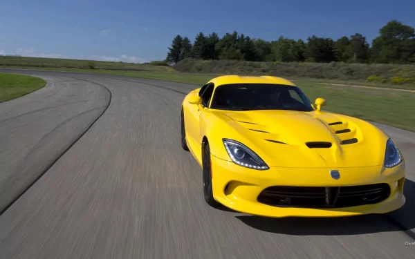 Yellow Dodge Viper speeding on a racetrack, dynamic low-angle shot — HD PC desktop wallpaper/background.