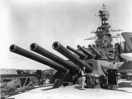 A close-up view of the USS California (BB-44) showcasing its massive naval artillery. This black-and-white image captures the battleship's formidable structure and military presence.