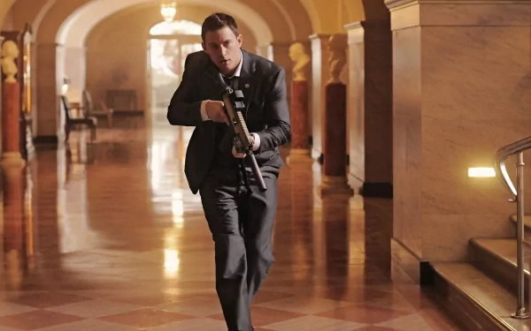 Channing Tatum races through the halls in a tense moment from the movie White House Down, captured in this striking HD wallpaper.