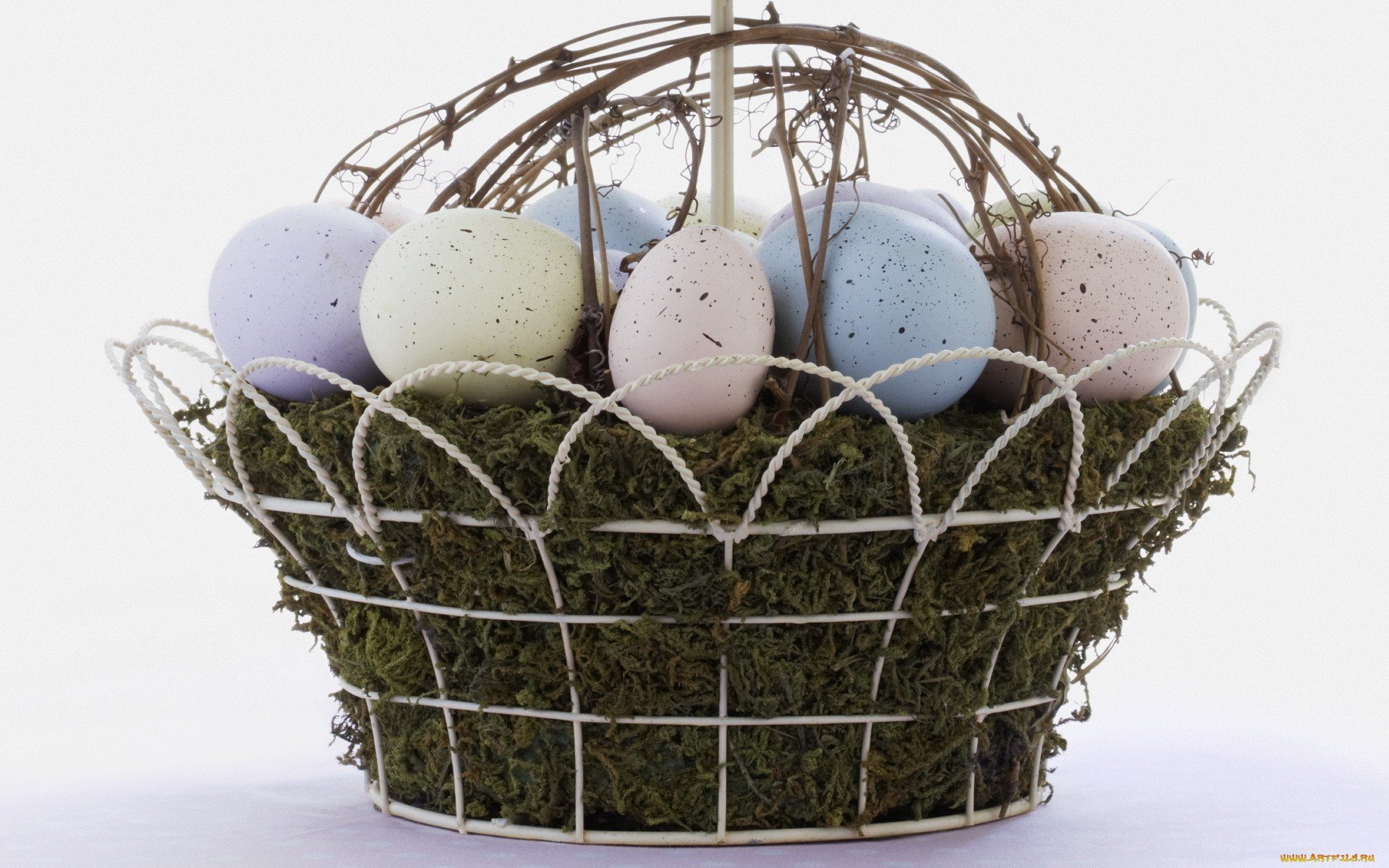 HD PC desktop wallpaper featuring pastel-colored Easter eggs arranged in a decorative wire and moss basket, celebrating the holiday with soft, muted tones.