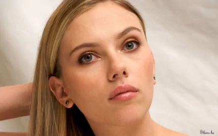HD desktop wallpaper featuring a close-up portrait of Scarlett Johansson, showcasing her natural beauty with soft lighting and a serene expression.