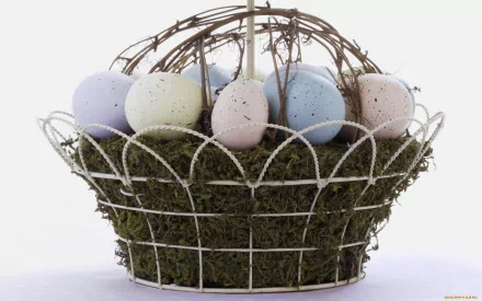 HD PC desktop wallpaper featuring pastel-colored Easter eggs arranged in a decorative wire and moss basket, celebrating the holiday with soft, muted tones.