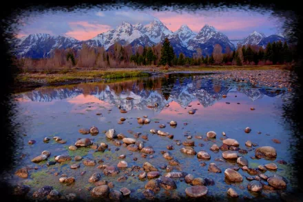 2K Quad HD PC desktop wallpaper: snow-capped mountains and trees reflected in a rocky foreground river under a pink sky — nature, reflection.