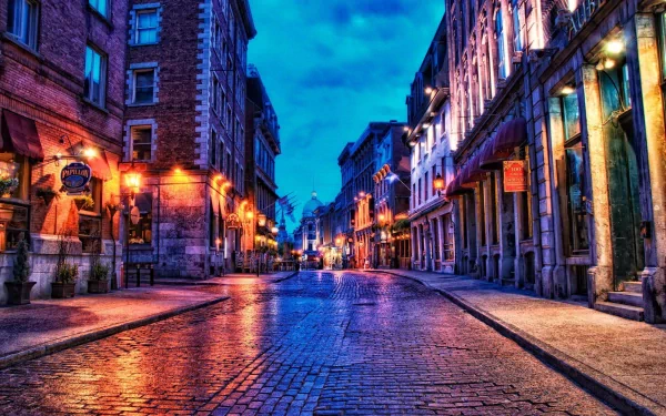A vibrant HDR image of a cobbled street in Montreal, illuminated by warm light under a dramatic sky, showcasing the city's urban charm and architectural beauty.
