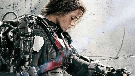 Emily Blunt in a striking pose from the movie Edge of Tomorrow, wearing a futuristic battle suit. This HD image serves as an engaging desktop wallpaper.