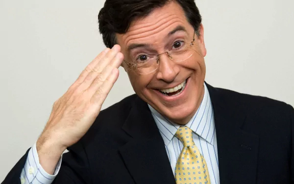 HD desktop wallpaper of Stephen Colbert from The Colbert Report, smiling with a hand salute.