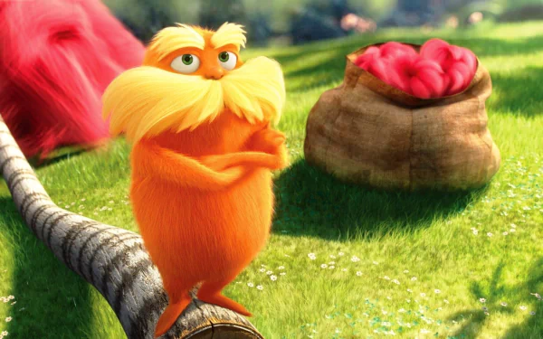 HD PC desktop wallpaper from the movie The Lorax featuring the orange, mustached Lorax character standing on a branch with a sack of red fruit in the background.