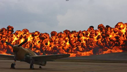 A military aircraft is stationed in front of a dramatic explosion, creating a striking HD wallpaper that captures the intensity of conflict.