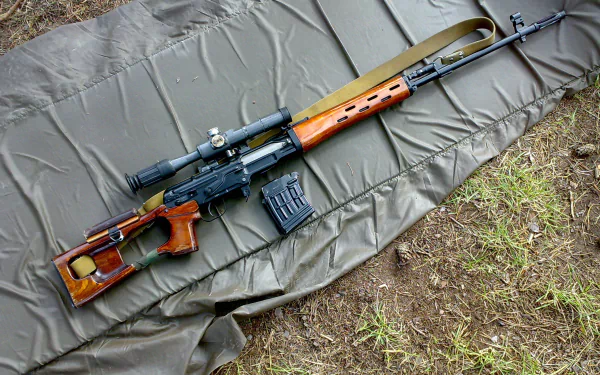 Man-made Dragunov sniper rifle with wooden stock and scope lying on a mat over grass — 2K Quad HD PC desktop wallpaper and background.