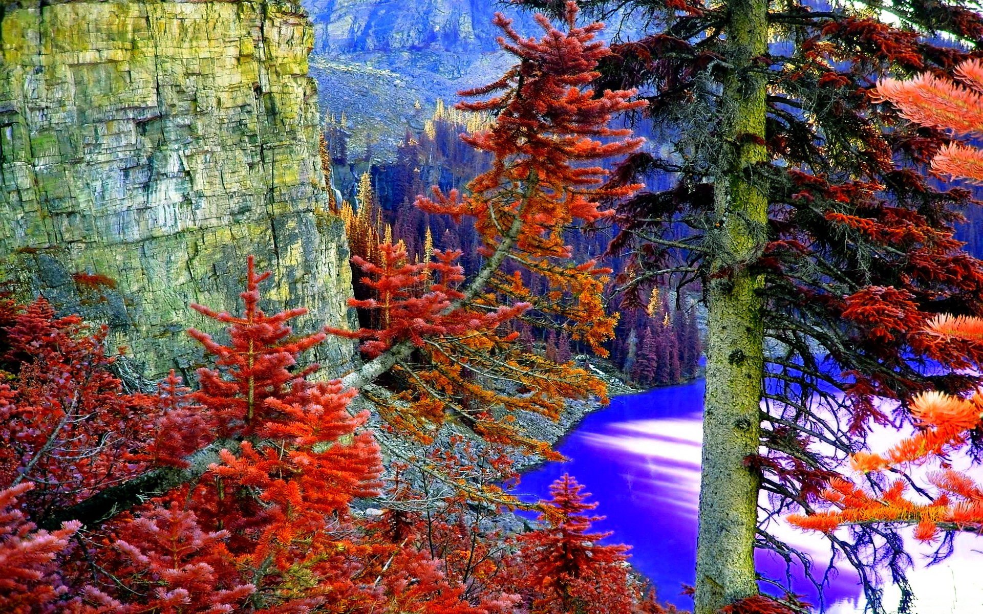 HD PC desktop wallpaper showcasing a vibrant nature landscape with red and orange trees beside cliffs overlooking a bright blue river under a clear sky.