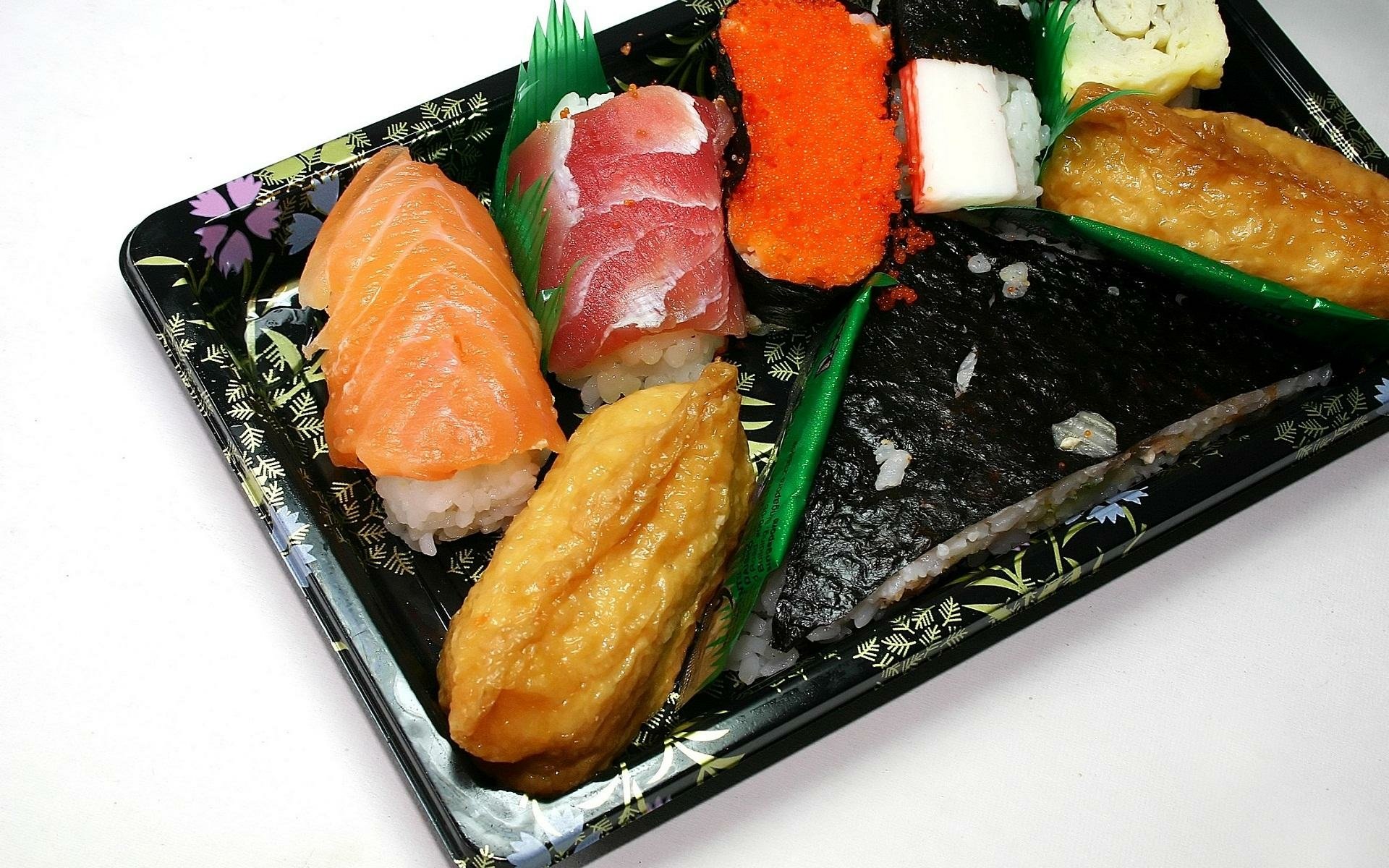 HD PC desktop wallpaper featuring a close-up of assorted sushi pieces in a black tray, highlighting vibrant colors and fresh ingredients.