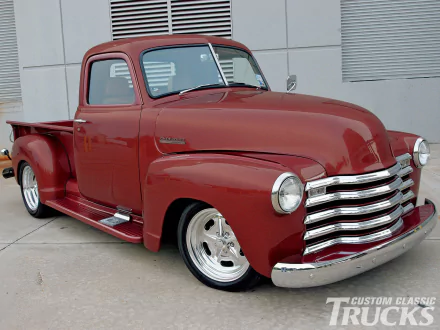 A deep red 1947 Chevrolet pickup truck with polished chrome and classic design, captured in high definition for a PC desktop wallpaper background.